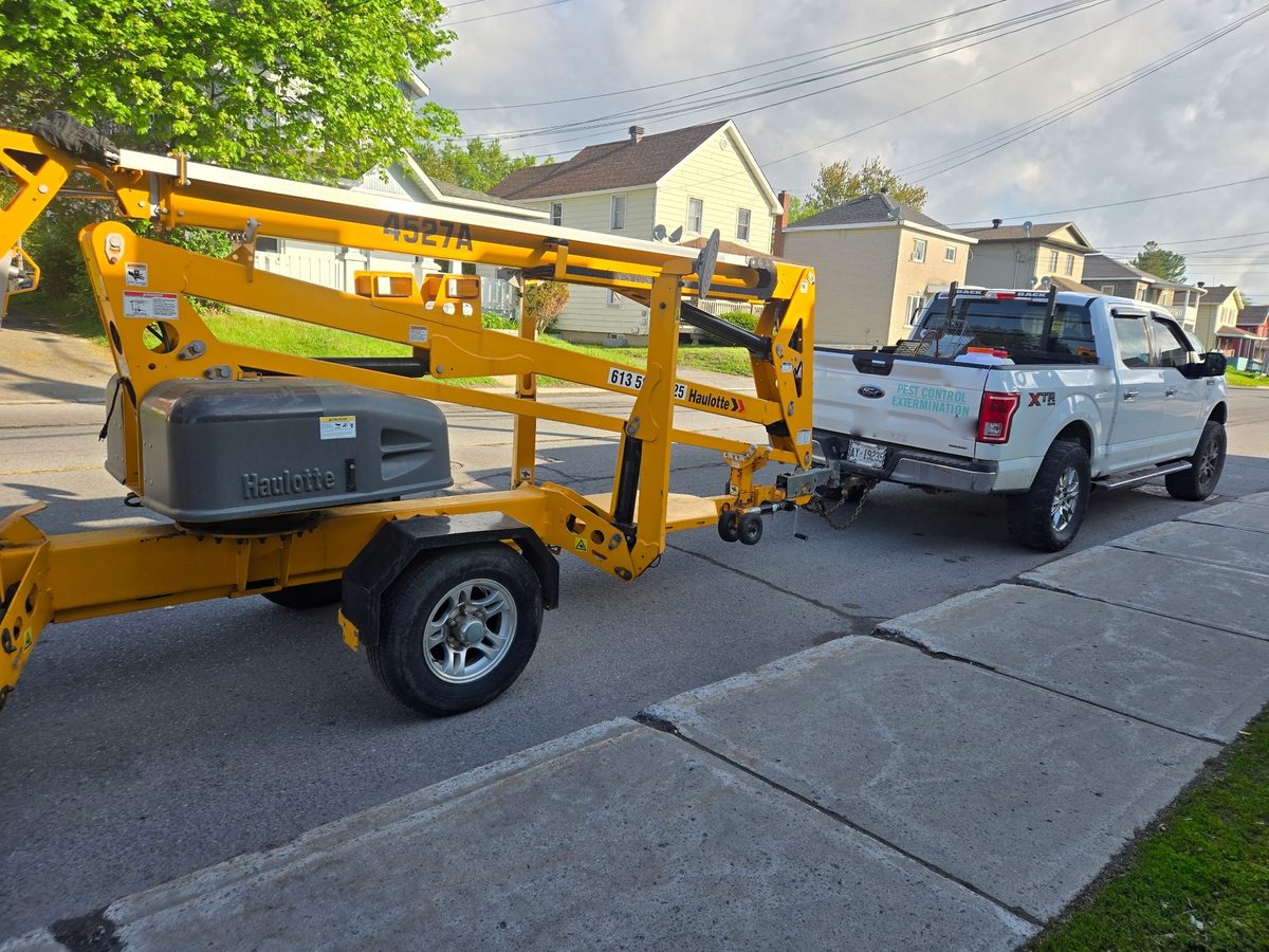 The truck and the boom lift that reaches work a ladder cannot